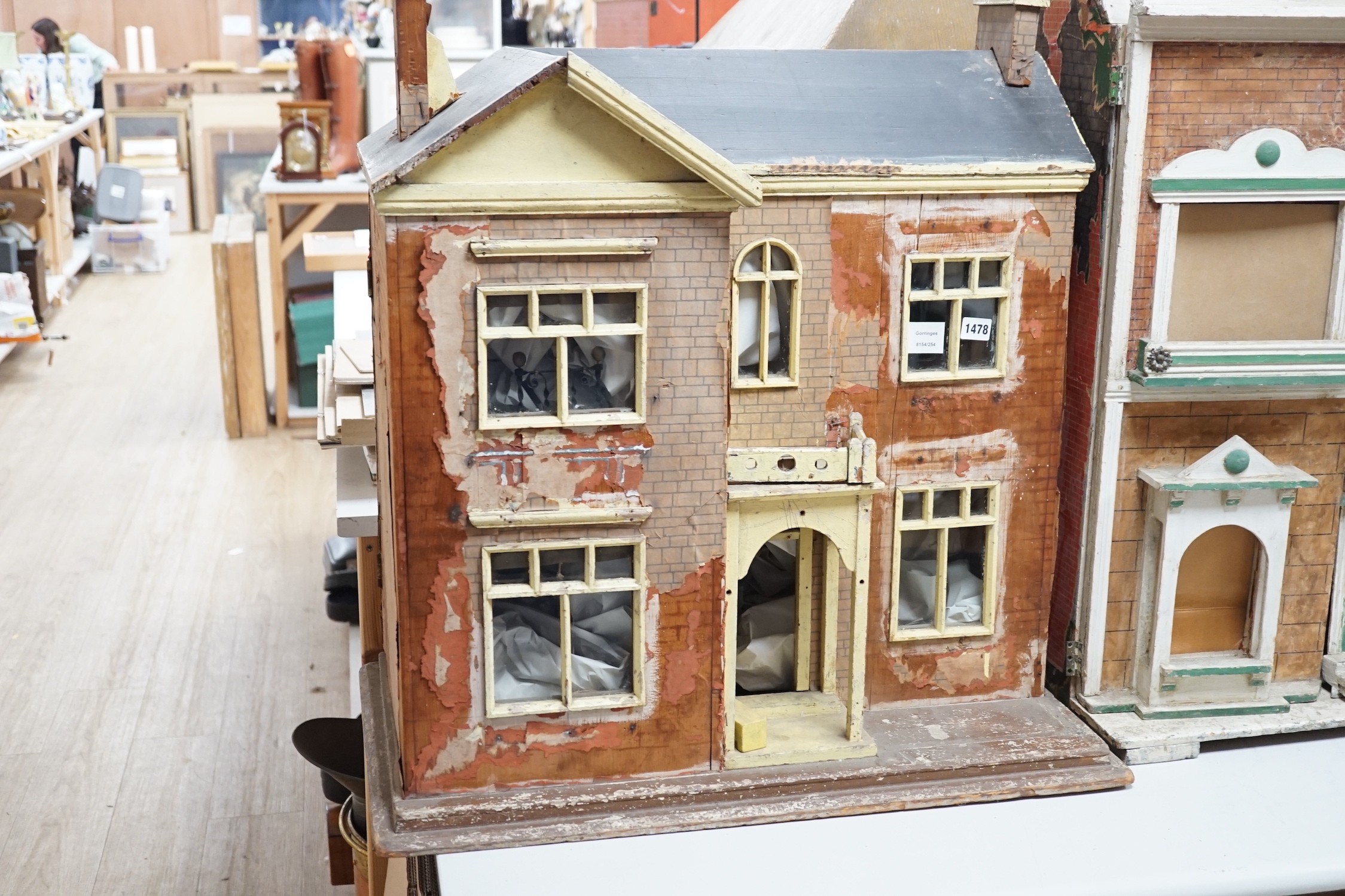 An English back-opening furnished dolls’ house, c.1900, modelled as a double-fronted brick villa, 75cms wide x 80cms high